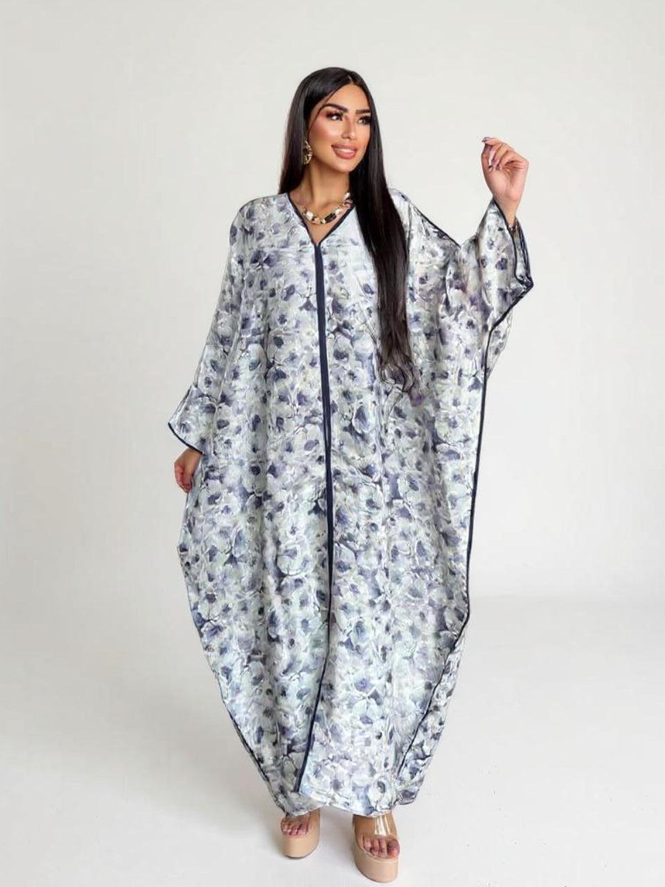 Woman wearing a floral dress with a white background